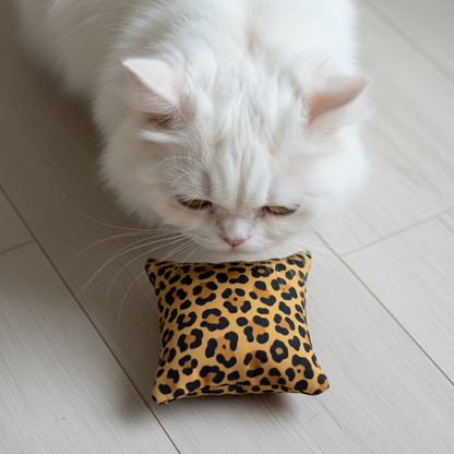 White cat sniffing a handmade valerian bean bag cat toy during quiet indoor play