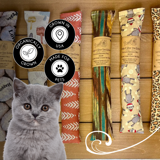 Handmade catnip and silver vine kicker cat toys in assorted fabrics by Shady Cat Social Club with gray cat