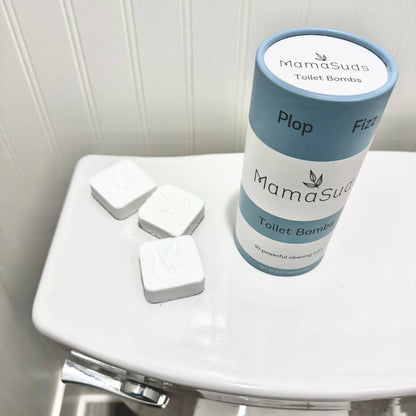 MamaSuds Toilet Bombs canister with natural toilet cleaning tablets displayed on toilet lid.