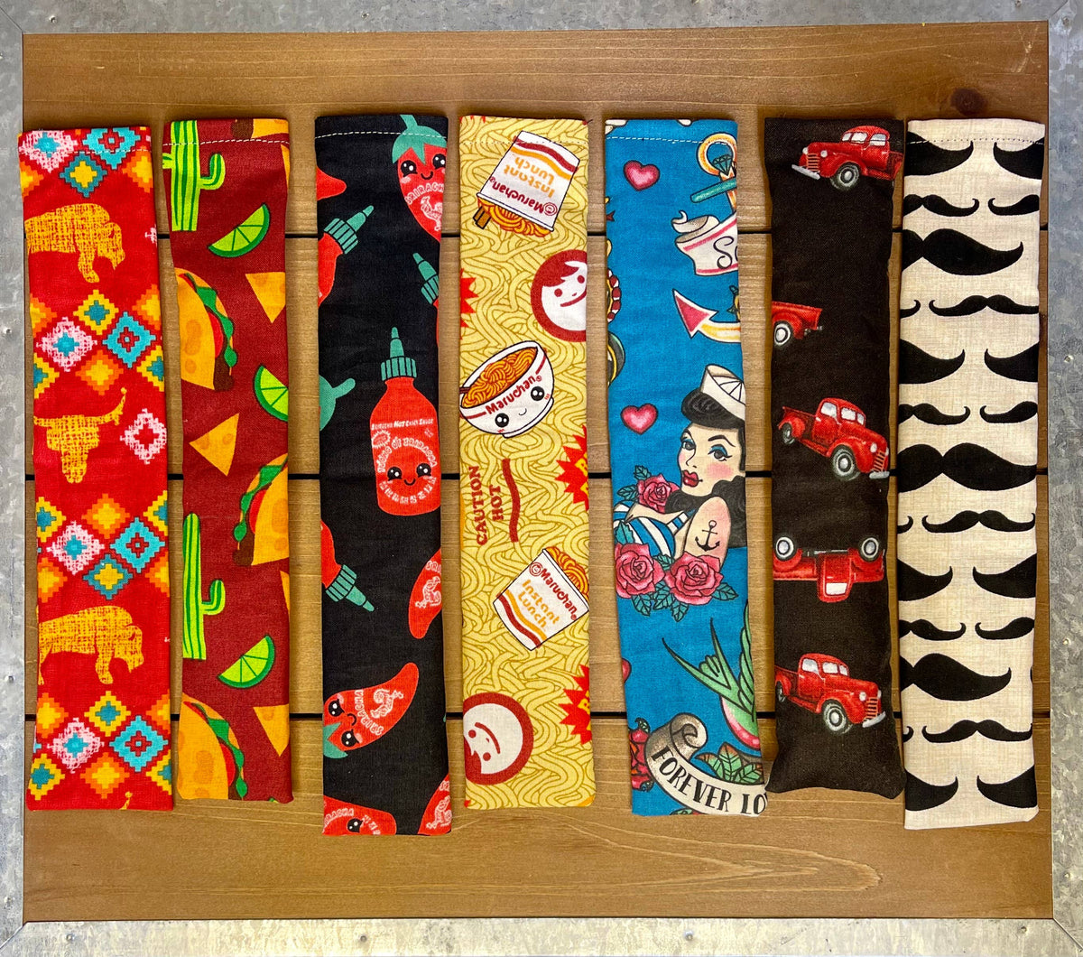 Assorted handmade catnip and silver vine kicker cat toys in colorful fabric patterns