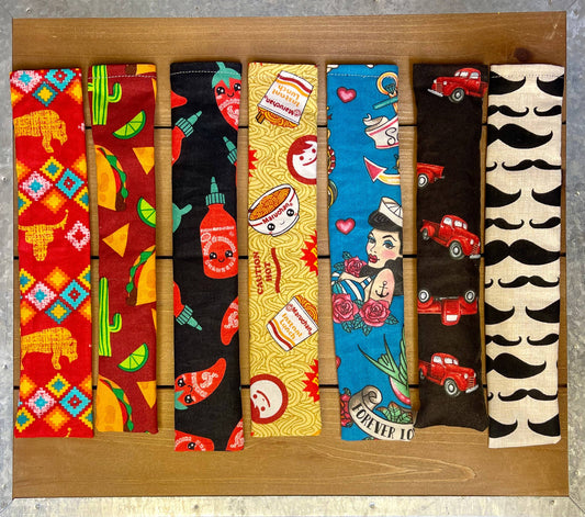 Assorted handmade catnip and silver vine kicker cat toys in colorful fabric patterns