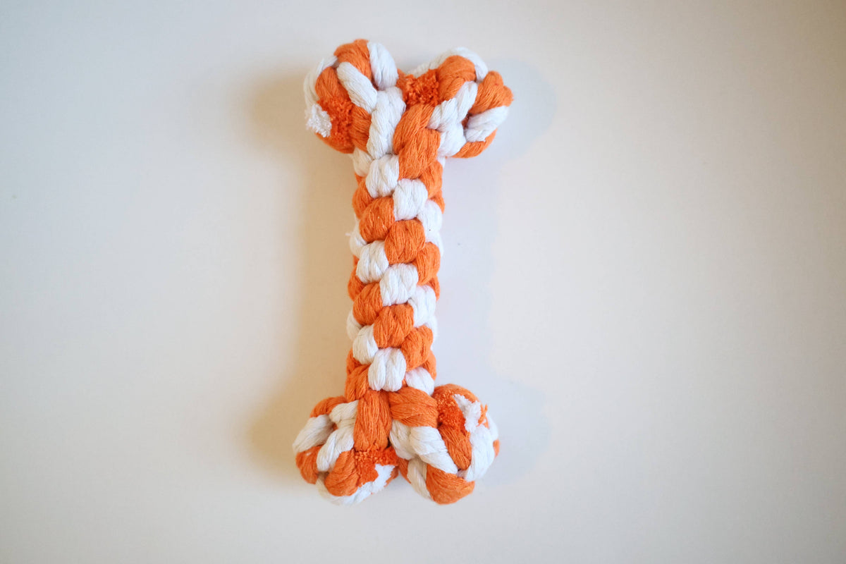 Handmade orange and white braided rope bone dog toy