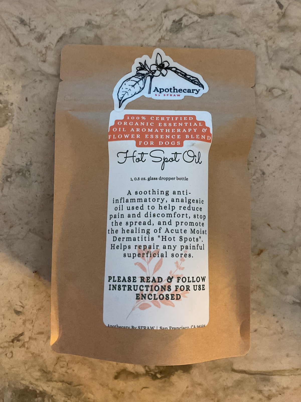 Organic Hot Spot Oil sealed in its Apothecary by SFRAW retail packaging before opening.