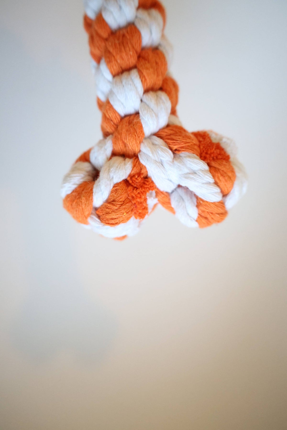 Close-up of the knotted end of a handmade rope bone dog toy