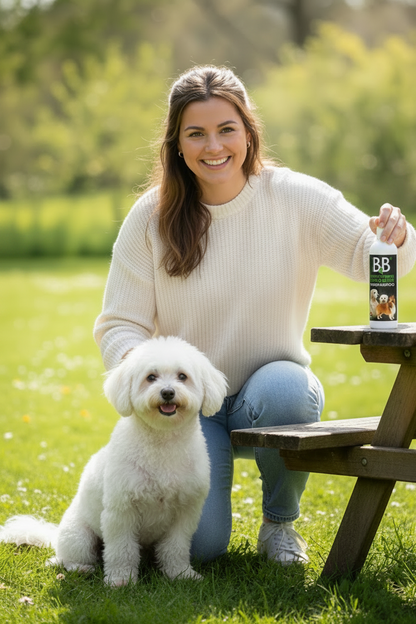 Dog owner with a clean, freshly groomed dog and B&B Organic Dry Shampoo Powder outdoors.