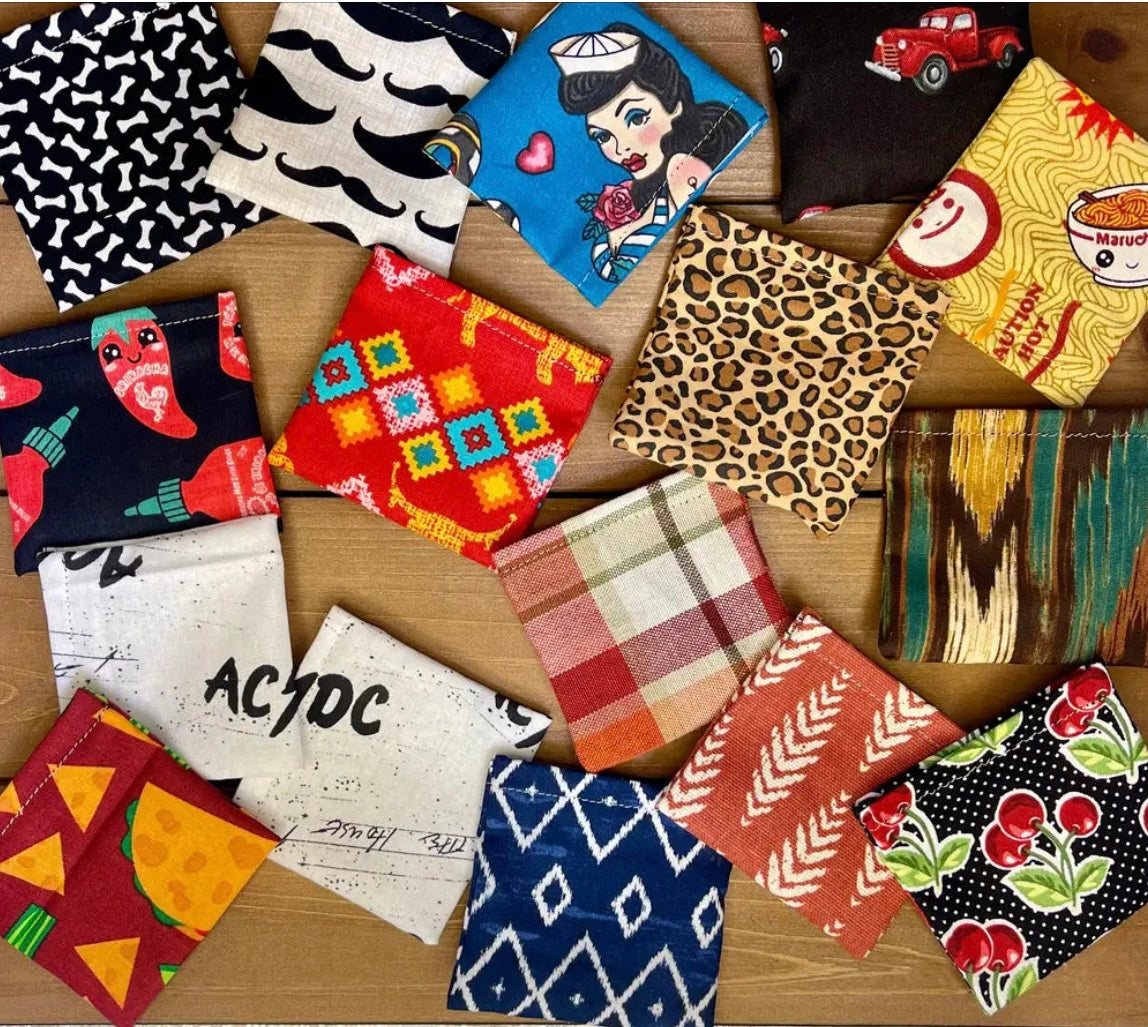 Assorted handmade catnip and silver vine bean bag cat toys in colorful fabric patterns