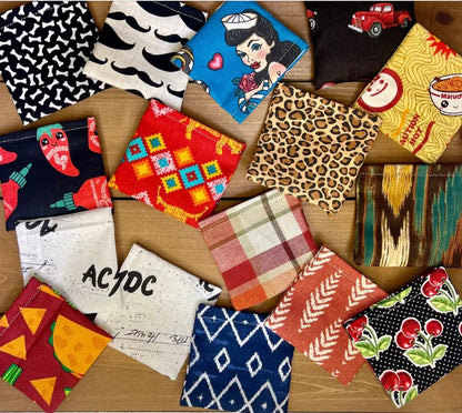 Assorted handmade catnip and silver vine bean bag cat toys in colorful fabric patterns