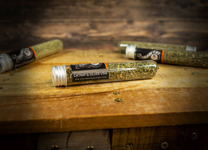 Close-up of Shady Cat organic catnip and silver vine blend tube on a wooden surface