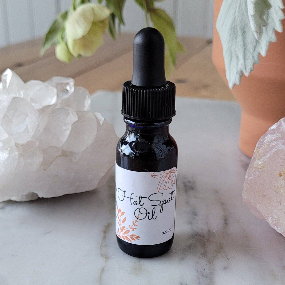 Organic Hot Spot Oil for dogs in a 0.5 oz amber glass dropper bottle made with certified organic herbal ingredients.
